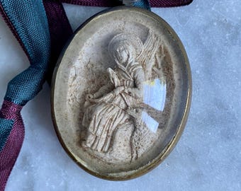 An antique French framed meerschaum relief of St Bernadette the shepherdess