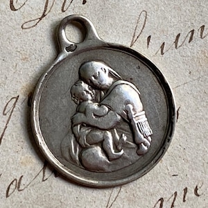 An antique French silver medal, Virgin Mary and infant Jesus, Holy Spirit