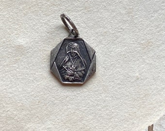 A tiny vintage French Emilie de Rodat medal