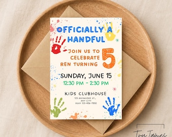 May include: A birthday invitation with the text "OFFICIALLY A HANDFUL" and "JOIN US TO CELEBRATE REN TURNING 5". The invitation is decorated with colorful handprints and is placed on a wooden plate with an envelope.