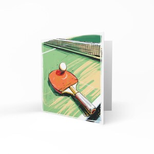 May include: A red and black ping pong paddle with a white ball on the green table with a net.