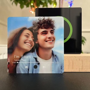 May include: A white ceramic mug with a black handle and the text "But First, Coffee" in a black, handwritten-style font. The mug is on a white surface.