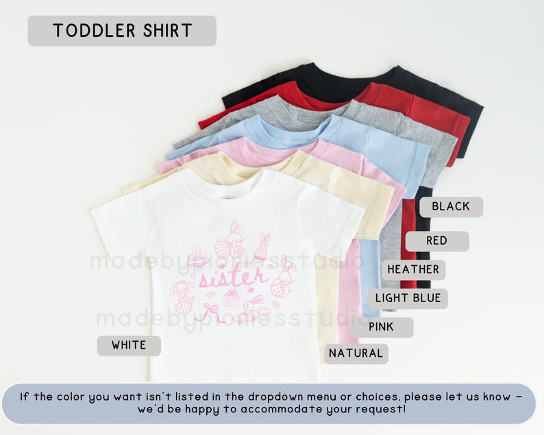 May include: A selection of toddler shirts in colours such as white, black, red, and light blue. The white shirt has a pink graphic with the word "sister". The text "TODDLER SHIRT" is at the top of the image.