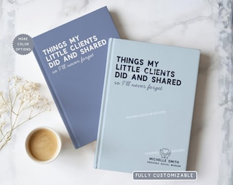 May include: Two hardcover notebooks, one periwinkle and one light blue, with the text "THINGS MY LITTLE CLIENTS DID AND SHARED so I'll never forget." A small cup of coffee and decorative flowers are also present.