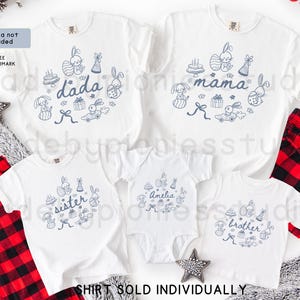 May include: White family shirts with blue bunny and Easter-themed graphics. The shirts are labelled "dada", "mama", "sister", "brother", and "Amelia". Red and black plaid pajama bottoms are visible.
