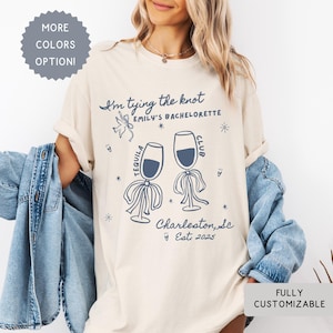 Comfort Colors® Personalized Coquette She&#39;s Tying the Knot Shirt, Custom Bow & Tequila Bachelorette Party Favors, Destination Bach Tee Gift