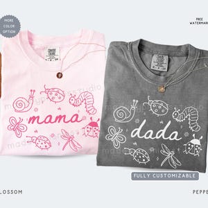 May include: Two t-shirts, one blossom pink and one pepper gray, each with a crew neck and short sleeves. The pink shirt says "mama" and the gray shirt says "dada", both with insect illustrations. Each shirt has a necklace.