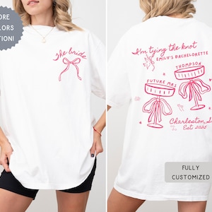 Comfort Colors® Personalized Coquette She&#39;s Tying the Knot Shirt, Custom Bow & Martini Bachelorette Party Favors, Destination Bach Tee Gift