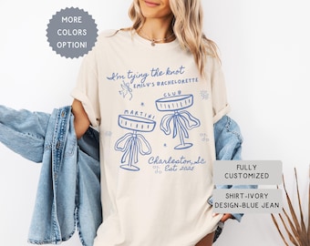Comfort Colors® Personalized Coquette She&#39;s Tying the Knot Shirt, Custom Bow & Martini Bachelorette Party Favors, Destination Bach Tee Gift
