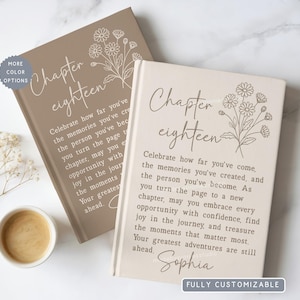May include: Two hardcover books with beige and taupe covers featuring a line art floral illustration and the text Chapter eighteen. The text reads: Celebrate how far you've come, the memories you've created, and the person you've become.