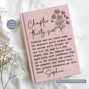 May include: A light pink hardcover book featuring a black line art floral illustration and the text Chapter thirty-five. The cover includes a printed message about celebrating memories and the name Sophia, with a small circular badge stating More color options.