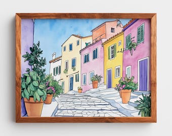 Pode incluir: Pintura em aquarela de uma cena de rua europeia com edifícios coloridos em tons de amarelo, rosa e laranja. Uma rua de paralelepípedos leva aos edifícios, com plantas em vasos adicionando vegetação. A obra de arte é emoldurada em uma moldura de madeira.