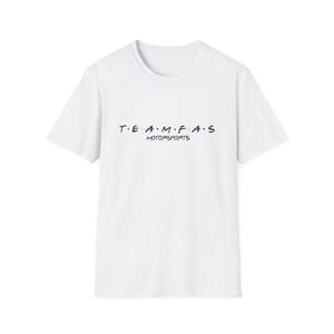 May include: White crew neck t-shirt featuring the text "TEAM F.A.S MOTORSPORTS" in black. The letter "O" in "MOTORSPORTS" is replaced with a red dot. The shirt is made of a soft, lightweight material.
