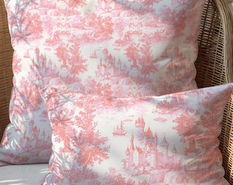 May include: Two square and rectangular throw pillows featuring a white background with a repeating coral pink toile pattern. The design displays detailed illustrations of castles, sailing ships, and trees across the fabric surface.