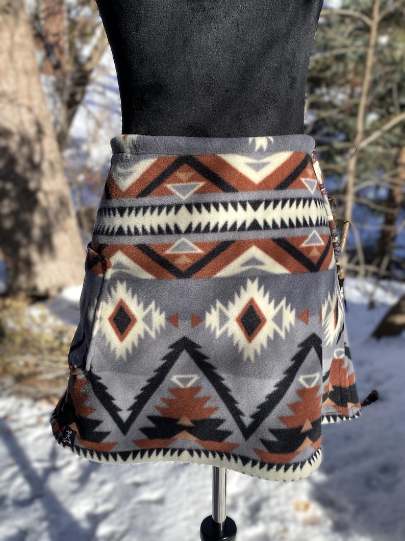Fleece Bum Warmer skirt. A-line with pocket large enough or a phone. beaded drawstring waist. Print: Black Raymi Southwest