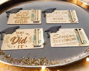 May include: Four wooden graduation cards with a graduation cap design and a slot for cash. The cards have different messages including "The tassel was worth the hassle", "Let the adventure begin - Class of 2025", "You did it", and "Senior 2025 Congratulations!"