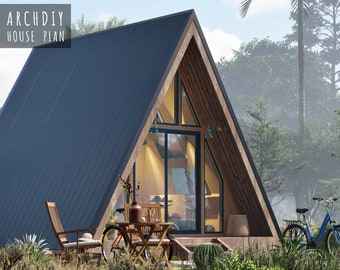 May include: A wooden A-frame cabin with a black metal roof. The cabin has large windows and a wooden deck. There are two chairs and a table on the deck, and a bicycle is leaning against the cabin.