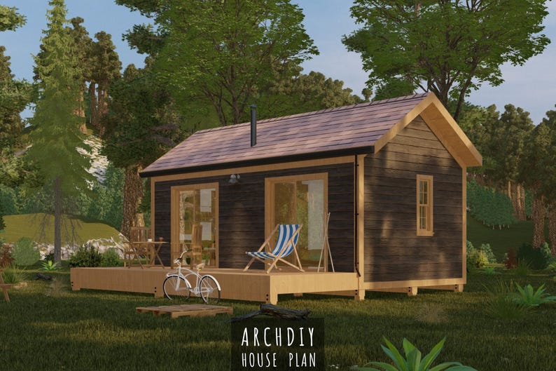 May include: A digital rendering of a small cabin with a wooden deck, a bicycle, and a striped chair. The cabin has a dark exterior, a brown roof, and a small window. The text "ARCHDIY HOUSE PLAN" is at the bottom of the image.