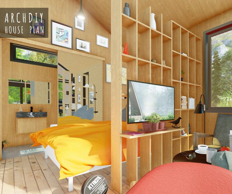 Interior view of the tiny house bedroom and living space featuring wood-paneled walls, an orange bedspread, and an open shelving room divider.