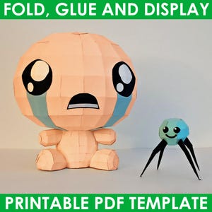 Pode incluir: Figuras de papel de um bebê chorando e uma pequena criatura parecida com uma aranha. O bebê tem olhos grandes e pretos e lágrimas azuis. As figuras são feitas de papel dobrado e são exibidas em um fundo branco. O texto na parte superior diz "FOLD, GLUE AND DISPLAY" e na parte inferior "PRINTABLE PDF TEMPLATE".