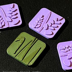May include: Four square tiles with floral designs. Three are lavender-colored, featuring lavender sprigs and other botanical elements. One tile is green with a brush-like design. Text reads "lavender duo" and "Relaxing, floral combo with 2 tiles: 'Lavender' and 'Brush'".