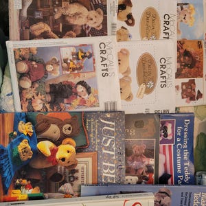 May include: A collection of craft books and patterns featuring teddy bears. The covers display various teddy bear designs, including dressed bears and patterns for making them. Titles include "Soft Toys" and "Just Be".