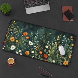 May include: A green floral mousepad with a watercolor design of orange, yellow, and white flowers. The mousepad is rectangular and has a black border.