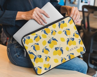 May include: A yellow laptop sleeve with a lemon print and the name "SARAH" in blue text. The sleeve is made of a soft, durable material and features a zipper closure.