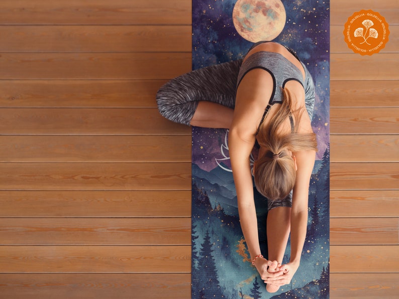 May include: A woman practices yoga on a blue and purple yoga mat with a moon and forest scene. The mat has a gold foil accent and the text "Goldenlia" printed on it.