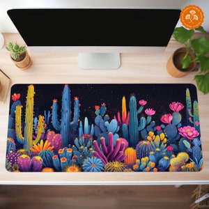 May include: A colorful desktop mouse pad featuring a variety of cacti and succulents in shades of blue, green, yellow, pink, and purple against a dark blue background with white speckles.