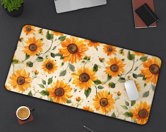 May include: A white mouse pad with a floral design featuring yellow sunflowers on a cream background. The mouse pad is on a black surface.
