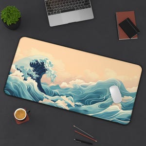 May include: A large blue and white wave design mouse pad with a beige background. The wave design is reminiscent of Japanese art.