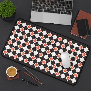 May include: A black and white checkered mouse pad with red flower accents. A white computer mouse is on the pad.