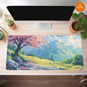 May include: A colorful desktop mouse pad with a scenic mountain landscape. The scene features a pink cherry blossom tree, a winding path, and a mountain range in the background. The mouse pad has a light blue sky with white clouds.