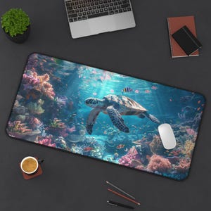 May include: A colourful desk mat featuring a sea turtle swimming through a coral reef. The mat has a blue background with coral, fish, and a sea turtle.
