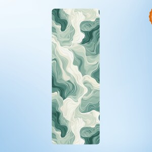 May include: A green and white yoga mat with a swirling, abstract pattern. The mat is made of a non-slip material and is perfect for yoga, Pilates, or stretching.