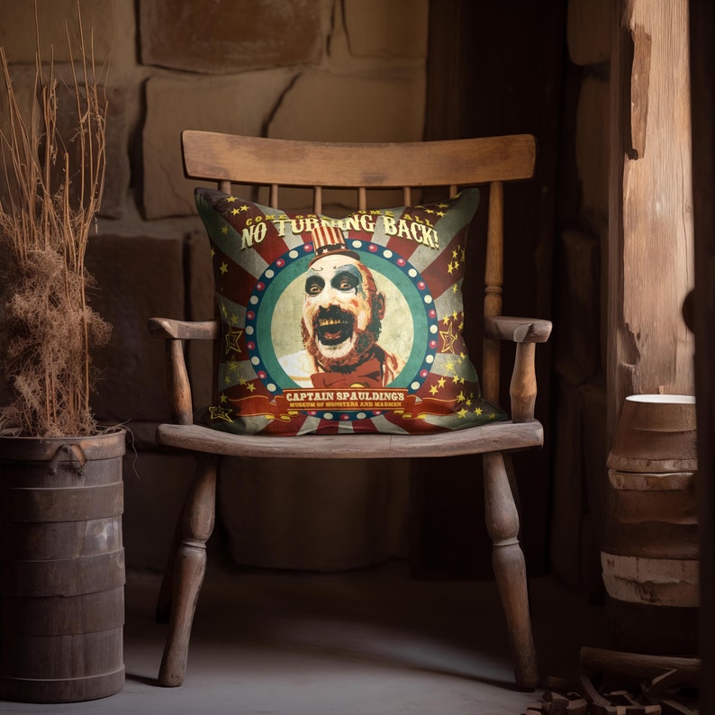 May include: A red, white, and blue throw pillow with a vintage circus poster design. The poster features a clown with a creepy smile and the text "Come One, Come All! No Turning Back!" and "Captain Spaulding's Museum of Monsters and Madmen".