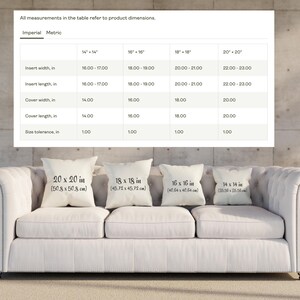 May include: A white couch with four throw pillows. The pillows are labeled with their dimensions in inches and centimeters. The pillows are 20 x 20 inches, 18 x 18 inches, 16 x 16 inches, and 14 x 14 inches.