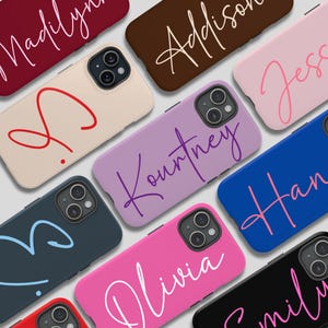 May include: Assortment of phone cases with various names written in different colors and styles. The cases are all for the iPhone 13 Pro Max.