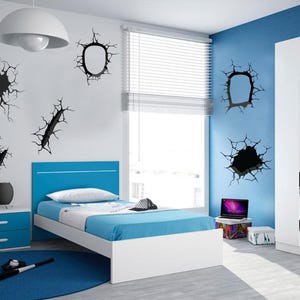 May include: A white bed frame with a blue headboard and a blue mattress. The bed is in a bedroom with blue walls and a white closet. There are black wall decals of cracked walls on the walls.