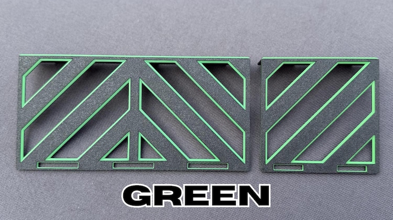 May include: Two geometric metal pieces, one rectangular and one square, with a black base and bright green diagonal lines and accents. The word "GREEN" is printed in bold white letters at the bottom.