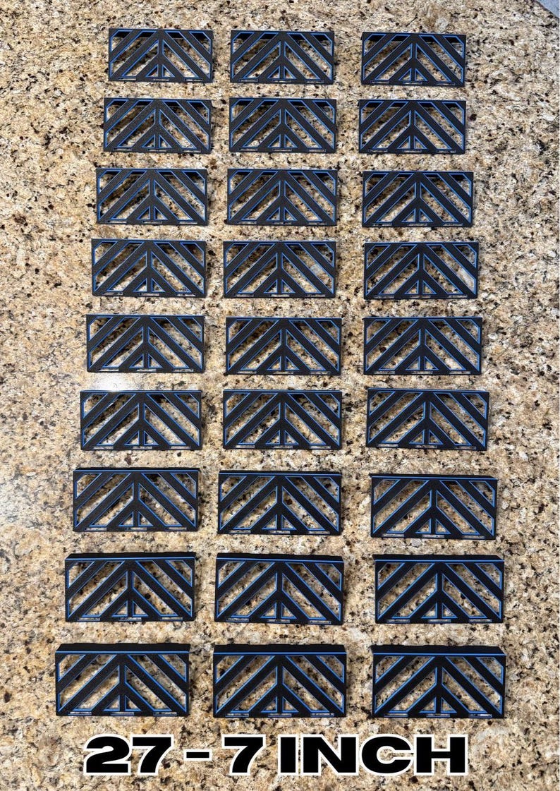 May include: Arrangement of black rectangular objects with a geometric chevron design. The objects are arranged in rows and columns. The text "27 - 7 INCH" is at the bottom of the image.