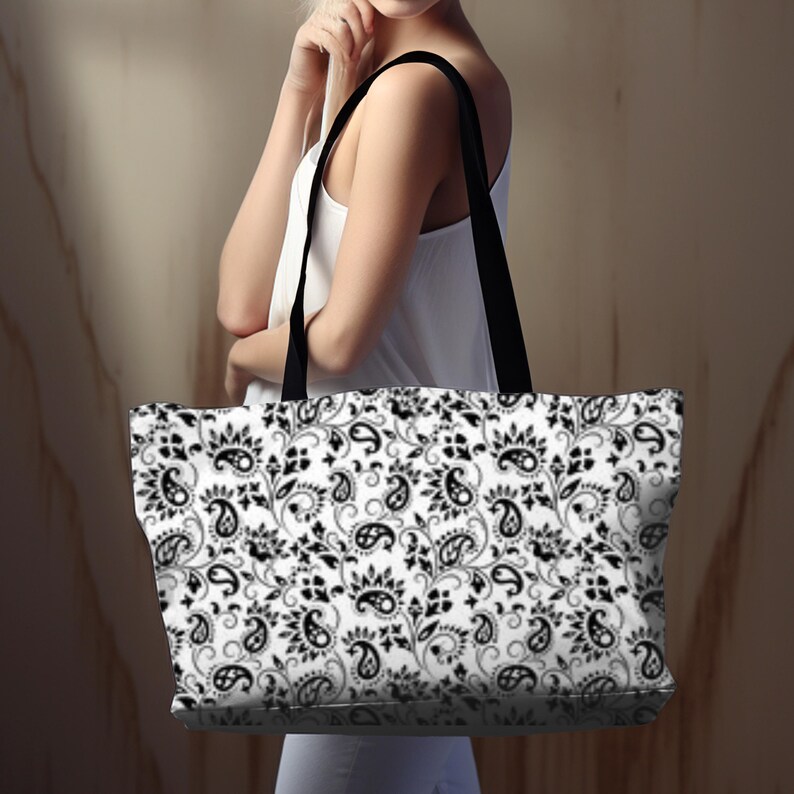 This Black And White Paisley Tote Bag is a large travel bag perfect for weekend getaways or trips to the beach. It makes a great gift for moms looking for a stylish and functional bag