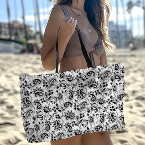 This Black And White Paisley Tote Bag is a large travel bag perfect for weekend getaways or trips to the beach. It makes a great gift for moms looking for a stylish and functional bag
