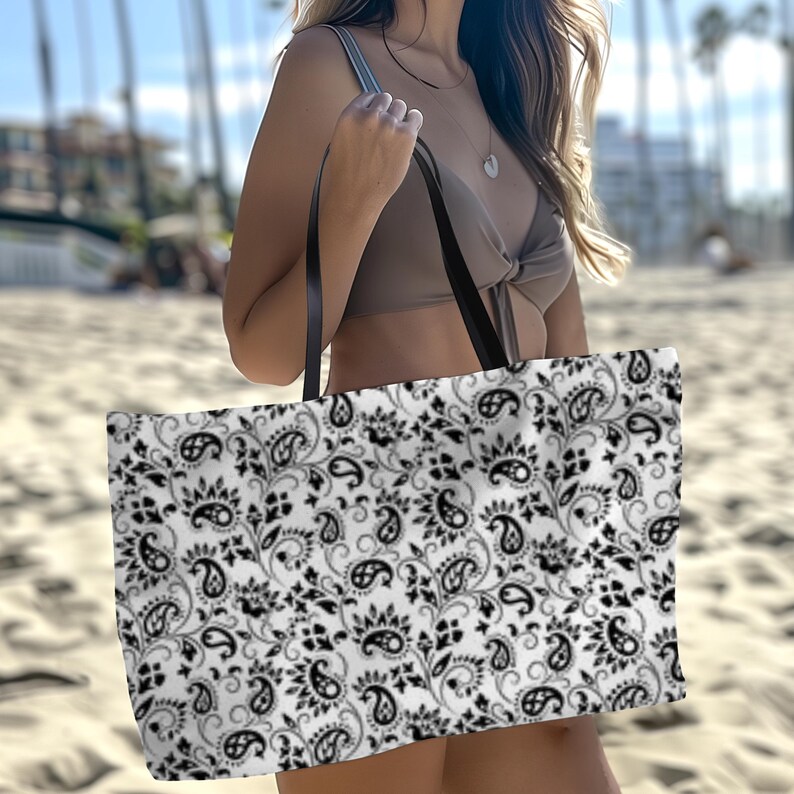This Black And White Paisley Tote Bag is a large travel bag perfect for weekend getaways or trips to the beach. It makes a great gift for moms looking for a stylish and functional bag