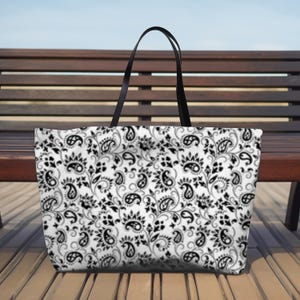 This Black And White Paisley Tote Bag is a large travel bag perfect for weekend getaways or trips to the beach. It makes a great gift for moms looking for a stylish and functional bag