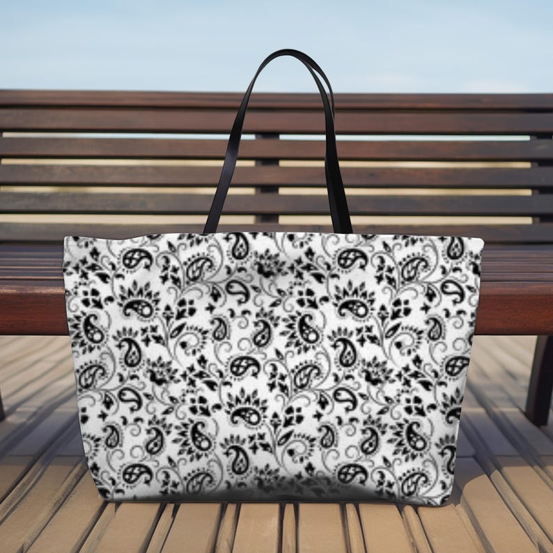 This Black And White Paisley Tote Bag is a large travel bag perfect for weekend getaways or trips to the beach. It makes a great gift for moms looking for a stylish and functional bag