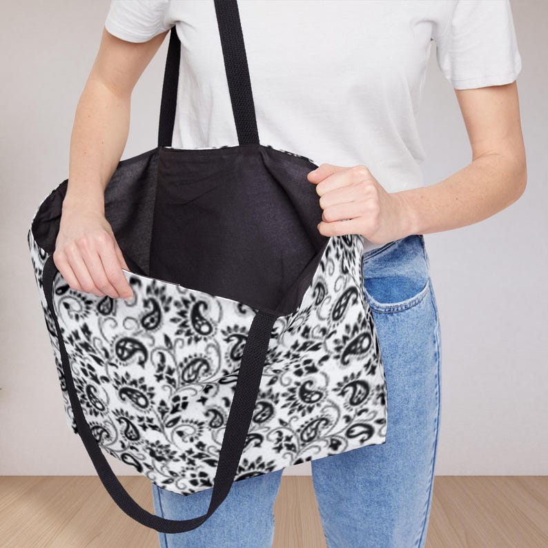This Black And White Paisley Tote Bag is a large travel bag perfect for weekend getaways or trips to the beach. It makes a great gift for moms looking for a stylish and functional bag