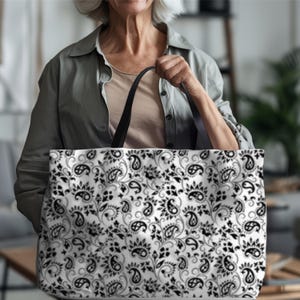 This Black And White Paisley Tote Bag is a large travel bag perfect for weekend getaways or trips to the beach. It makes a great gift for moms looking for a stylish and functional bag