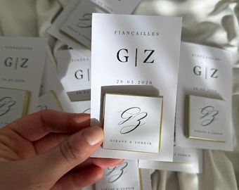 May include: White cards with the text "FIANÇAILLES" and initials "G|Z" with the date "28.03.2026". Some cards have a gold border and the names "GIHANE & ZOHEIR".